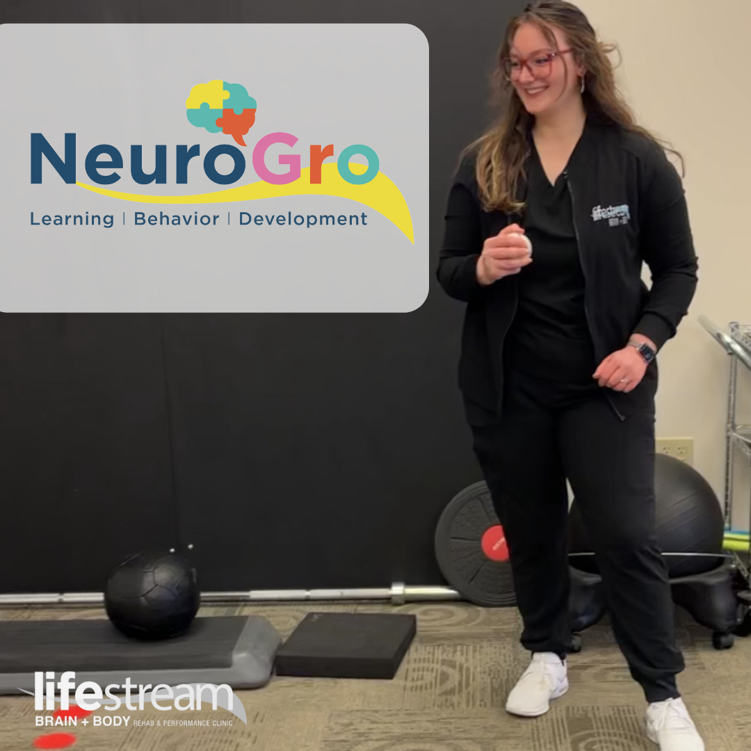Hannah standing in front of a wall, holding a ball for the NeuroGro program